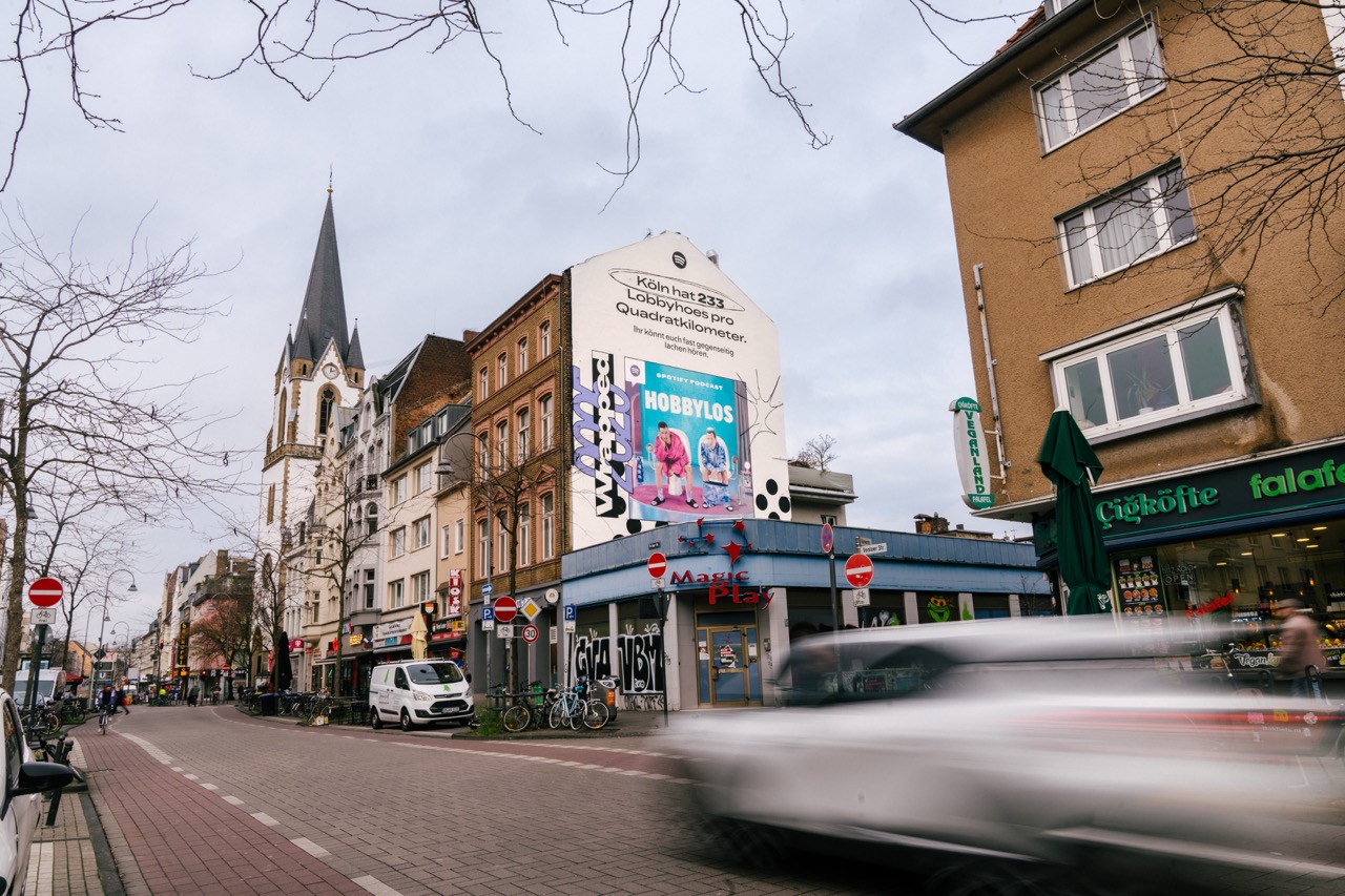 Weitwinkel-Drohnenaufnahme des Spotify Wrapped Murals in Köln mit umliegender Stadtlandschaft und Kirchturm.